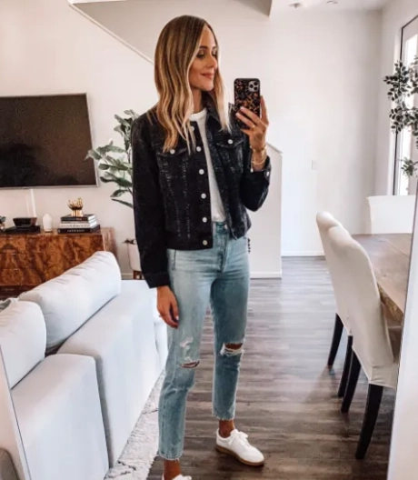Pairing a Black Denim Jacket and Ripped Jeans and Sneakers